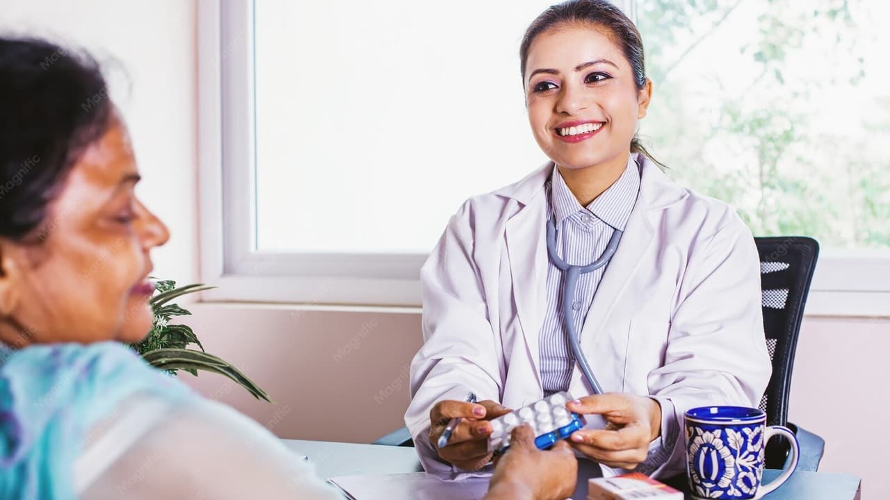 Senior Indian doctor attending to elderly parents in hospital