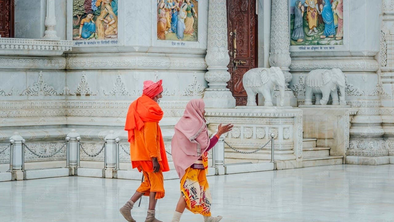 Indian senior couple praying peacefully inside community Mandir